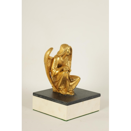 530 - A LATE 19TH CENTURY FRENCH GILT BRONZE SCULPTURE depicting a crouching winged angel, mounted on a la... 