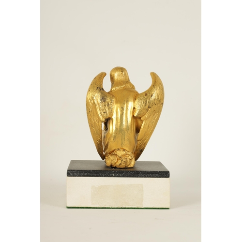 530 - A LATE 19TH CENTURY FRENCH GILT BRONZE SCULPTURE depicting a crouching winged angel, mounted on a la... 