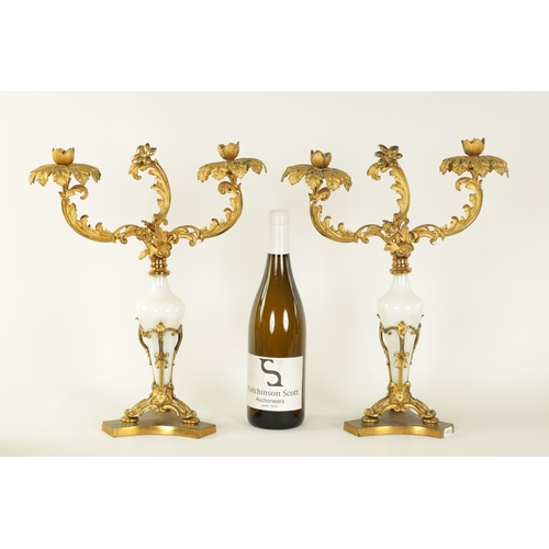 532 - A PAIR OF 19TH CENTURY TWO BRANCH ORMOLU AND OPAQUE GLASS CANDELABRA with leaf cast branchwork arms ... 