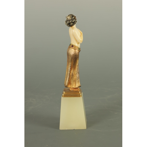 533 - AN ART DECO GILT BRONZE AND IVORY FIGURE the semi-nude female dancer wearing a gilt bronze skirt wit... 