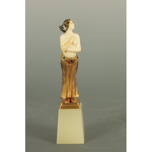 533 - AN ART DECO GILT BRONZE AND IVORY FIGURE the semi-nude female dancer wearing a gilt bronze skirt wit... 