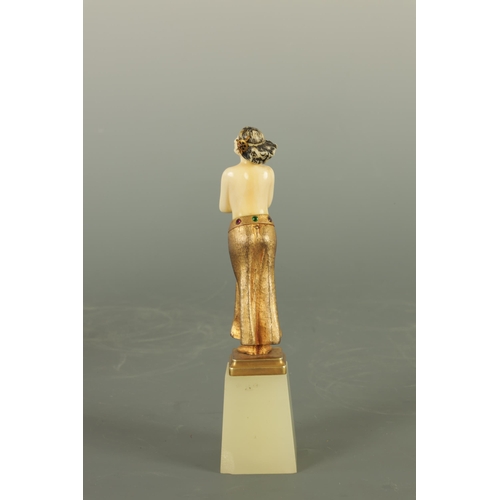 533 - AN ART DECO GILT BRONZE AND IVORY FIGURE the semi-nude female dancer wearing a gilt bronze skirt wit... 