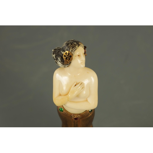 533 - AN ART DECO GILT BRONZE AND IVORY FIGURE the semi-nude female dancer wearing a gilt bronze skirt wit... 