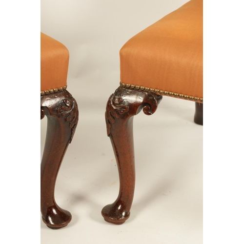 1004 - A PAIR OF GEORGE II MAHOGANY UPHOLSTERED SIDE CHAIRS with rectangular covered backs and seats, raise... 