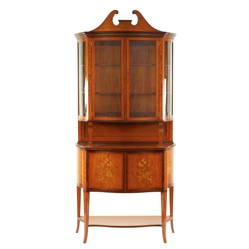 995 - EDWARDS AND ROBERTS. A FINE EDWARDIAN INLAID SATINWOOD SERPENTINE SHAPED DISPLAY CABINET with swan-n... 