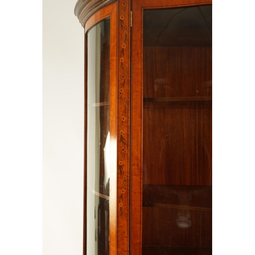 995 - EDWARDS AND ROBERTS. A FINE EDWARDIAN INLAID SATINWOOD SERPENTINE SHAPED DISPLAY CABINET with swan-n... 