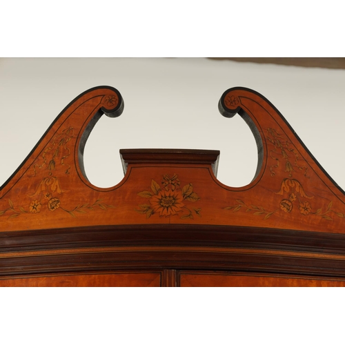 995 - EDWARDS AND ROBERTS. A FINE EDWARDIAN INLAID SATINWOOD SERPENTINE SHAPED DISPLAY CABINET with swan-n... 