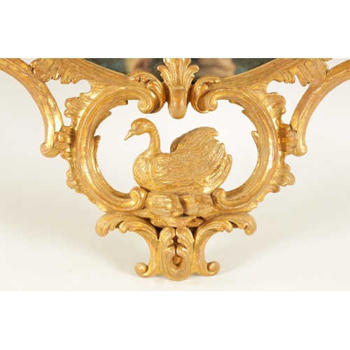 996 - A FINE MID 18TH CENTURY OVAL CARVED GILT GESSO HANGING MIRROR IN THE MANNER OF THOMAS CHIPPENDALE of... 