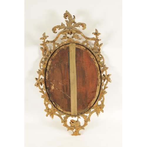 996 - A FINE MID 18TH CENTURY OVAL CARVED GILT GESSO HANGING MIRROR IN THE MANNER OF THOMAS CHIPPENDALE of... 