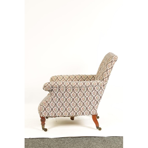 997 - HOWARD AND SONS. A 19TH CENTURY WALNUT FRAMED UPHOLSTERED ARMCHAIR with butttoned back and raised ar... 