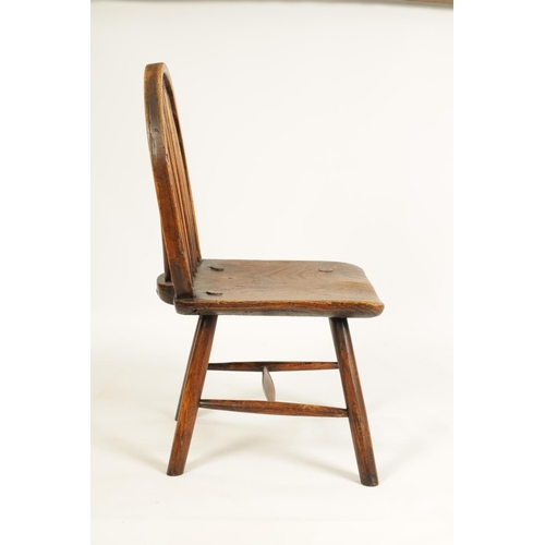 999 - AN 18TH CENTURY PRIMITIVE ASH AND ELM STICK BACK CHILD'S CHAIR with hooped stick back and splayed le... 