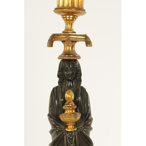 541 - A FINE PAIR OF REGENCY FIGURAL BRONZE AND ORMOLU CANDLESTICKS with shaped sconces above Egyptian sty... 