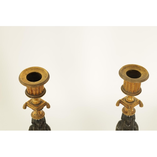 541 - A FINE PAIR OF REGENCY FIGURAL BRONZE AND ORMOLU CANDLESTICKS with shaped sconces above Egyptian sty... 