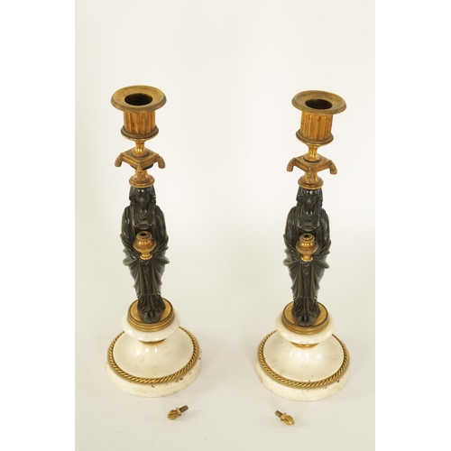 541 - A FINE PAIR OF REGENCY FIGURAL BRONZE AND ORMOLU CANDLESTICKS with shaped sconces above Egyptian sty... 