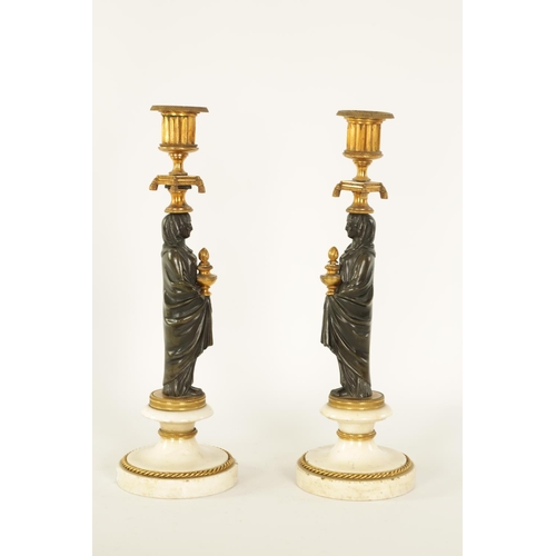 541 - A FINE PAIR OF REGENCY FIGURAL BRONZE AND ORMOLU CANDLESTICKS with shaped sconces above Egyptian sty... 