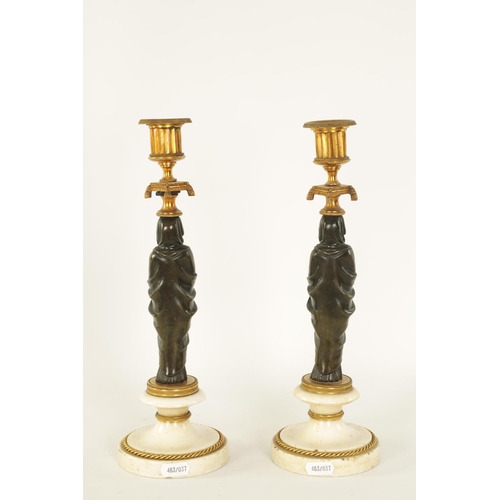 541 - A FINE PAIR OF REGENCY FIGURAL BRONZE AND ORMOLU CANDLESTICKS with shaped sconces above Egyptian sty... 