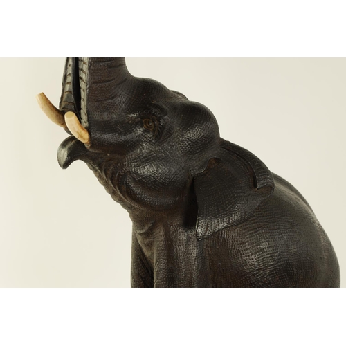 546 - A STYLISH EARLY 20TH CENTURY AESTHETIC CARVED WALNUT AND EBONISED TABLE LAMP MODELLED AS AN ELEPHANT... 