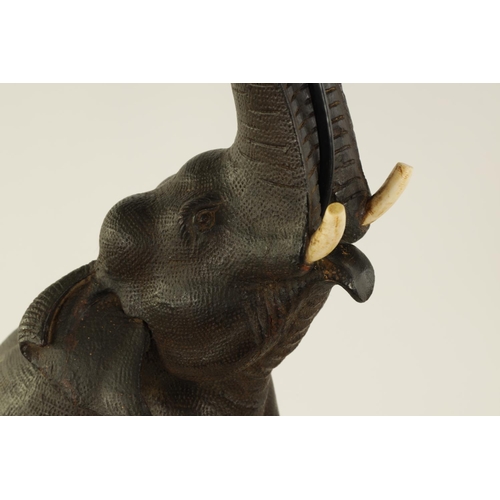 546 - A STYLISH EARLY 20TH CENTURY AESTHETIC CARVED WALNUT AND EBONISED TABLE LAMP MODELLED AS AN ELEPHANT... 