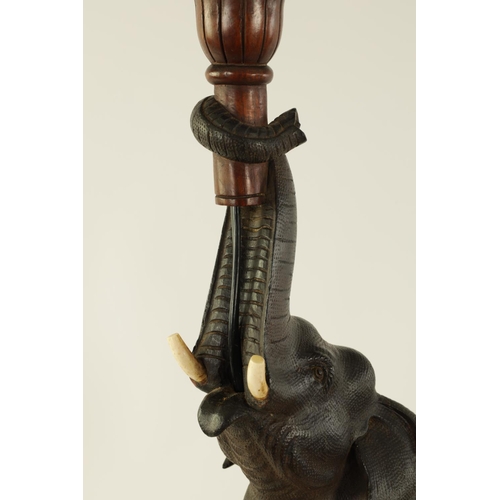 546 - A STYLISH EARLY 20TH CENTURY AESTHETIC CARVED WALNUT AND EBONISED TABLE LAMP MODELLED AS AN ELEPHANT... 