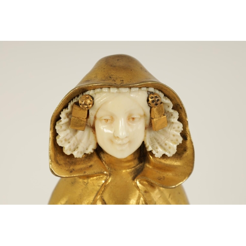 551 - E BERNOUD AN ART NOUVEAU FRENCH GILT BRONZE AND IVORY FIGURAL BRONZE depiciting a Dutch girl wearing... 