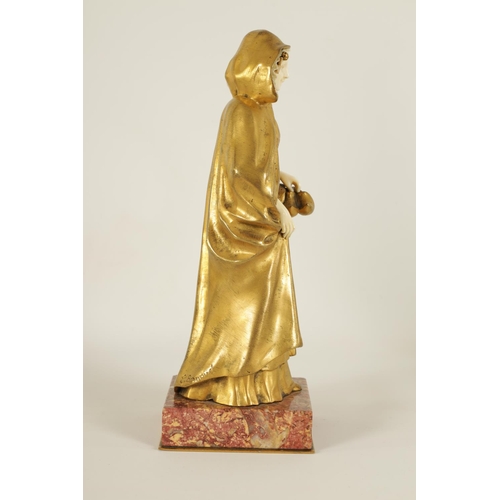 551 - E BERNOUD AN ART NOUVEAU FRENCH GILT BRONZE AND IVORY FIGURAL BRONZE depiciting a Dutch girl wearing... 