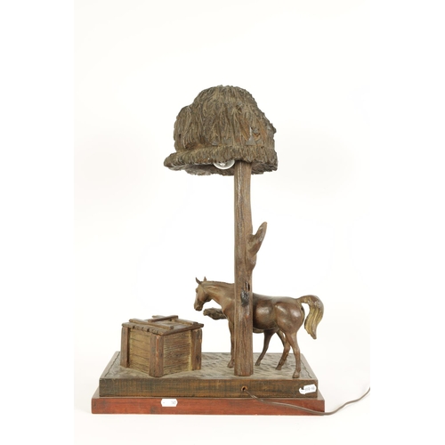 557 - A FINE 20TH CENTURY CARVED WALNUT BLACK FOREST EQUESTRIAN DESK LAMP with mare and foal by a lidded b... 