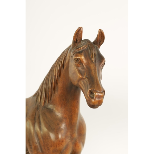 561 - A LATE 19TH CENTURY SWISS CARVED WOOD EQUESTRIAN SCULPTURE depicting a standing horse on plinth base... 