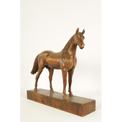 561 - A LATE 19TH CENTURY SWISS CARVED WOOD EQUESTRIAN SCULPTURE depicting a standing horse on plinth base... 