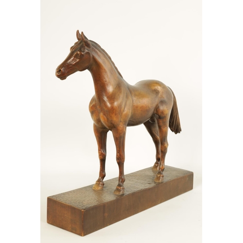 561 - A LATE 19TH CENTURY SWISS CARVED WOOD EQUESTRIAN SCULPTURE depicting a standing horse on plinth base... 