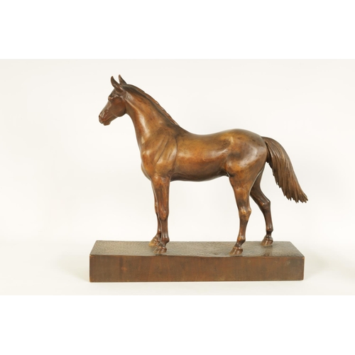 561 - A LATE 19TH CENTURY SWISS CARVED WOOD EQUESTRIAN SCULPTURE depicting a standing horse on plinth base... 