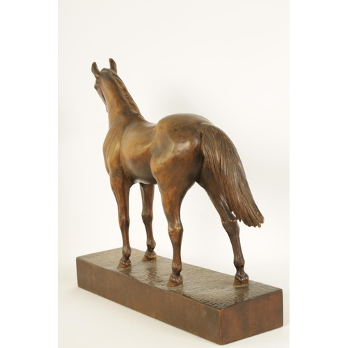 561 - A LATE 19TH CENTURY SWISS CARVED WOOD EQUESTRIAN SCULPTURE depicting a standing horse on plinth base... 