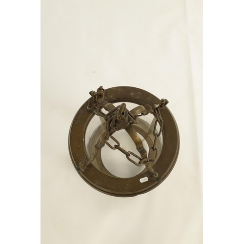 566 - AN UNUSUAL 19TH CENTURY BRASS CIRCULAR HANGING LANTERN of cylindrical glazed panelled form beneath s... 