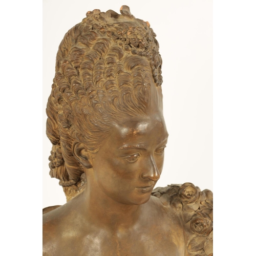 577 - A 19TH CENTURY CONTINENTAL TERRACOTTA BUST OF A YOUNG LADY with plaited hair and flowers to her dres... 