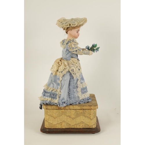 580 - A LATE 19TH CENTURY FRENCH MUSICAL AUTOMATON DOLL with moving bisque head and arms wearing a lacewor... 