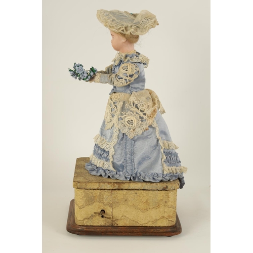 580 - A LATE 19TH CENTURY FRENCH MUSICAL AUTOMATON DOLL with moving bisque head and arms wearing a lacewor... 