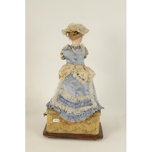 580 - A LATE 19TH CENTURY FRENCH MUSICAL AUTOMATON DOLL with moving bisque head and arms wearing a lacewor... 