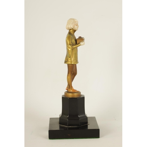 585 - FERDINAND PREISS (1882-1943). AN ART DECO GILT BRONZE AND IVORY FIGURE depicting a young boy holding... 