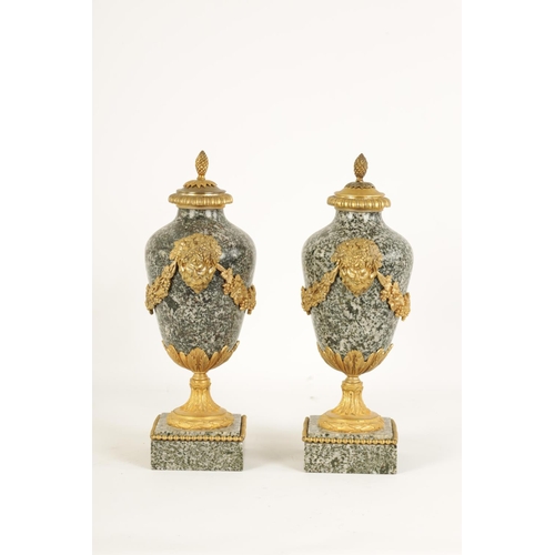 590 - A PAIR OF 19TH CENTURY FRENCH ORMOLU MOUNTED GREY FLECKED MARBLE CASSOLETTES the lidded urn-shaped b... 