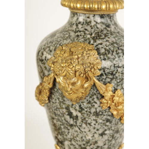 590 - A PAIR OF 19TH CENTURY FRENCH ORMOLU MOUNTED GREY FLECKED MARBLE CASSOLETTES the lidded urn-shaped b... 