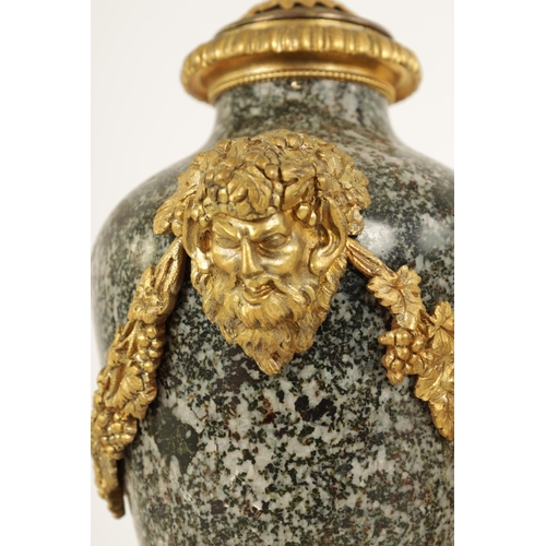 590 - A PAIR OF 19TH CENTURY FRENCH ORMOLU MOUNTED GREY FLECKED MARBLE CASSOLETTES the lidded urn-shaped b... 