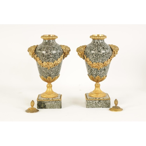 590 - A PAIR OF 19TH CENTURY FRENCH ORMOLU MOUNTED GREY FLECKED MARBLE CASSOLETTES the lidded urn-shaped b... 