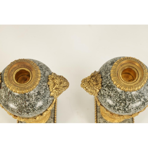 590 - A PAIR OF 19TH CENTURY FRENCH ORMOLU MOUNTED GREY FLECKED MARBLE CASSOLETTES the lidded urn-shaped b... 