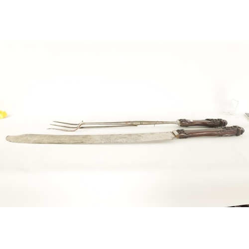 600 - A RARE GIANT PAIR OF LATE REGENCY EXHIBITION CARVING KNIFE AND FORK SET with substantial leaf-carved... 