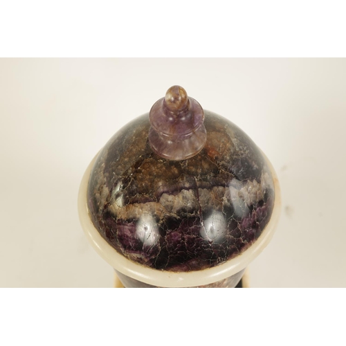 601 - A 19TH CENTURY BLUE JOHN COVERED URN mounted on a square veined agate plinth base (44cm high)