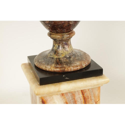 601 - A 19TH CENTURY BLUE JOHN COVERED URN mounted on a square veined agate plinth base (44cm high)