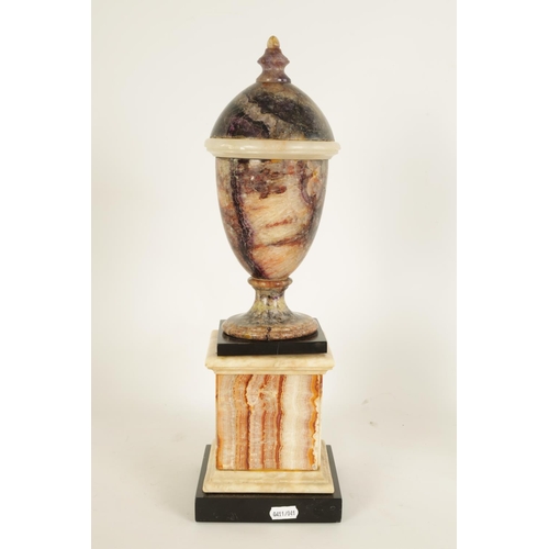 601 - A 19TH CENTURY BLUE JOHN COVERED URN mounted on a square veined agate plinth base (44cm high)