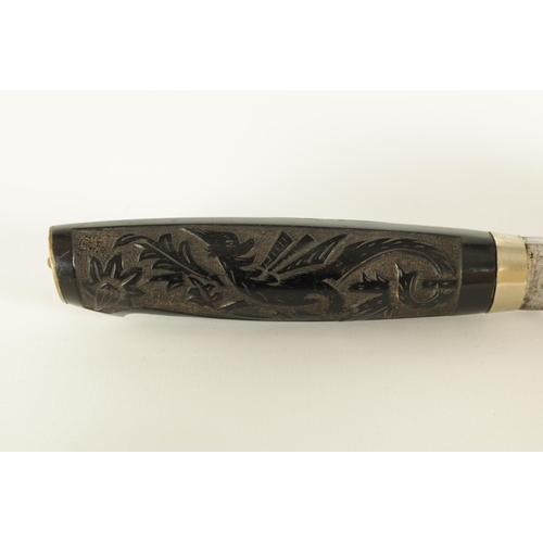 631 - A LATE 19TH CENTURY NORWEGIAN EBONY HANDLED KNIFE the handle relief carved depicting a dragon amidst... 