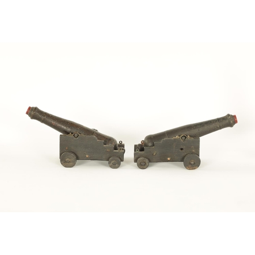 658 - A PAIR OF 19TH CENTURY CARVED WOOD CANNON MODELS modelled from the armour of Lord Nelson's HMS Victo... 