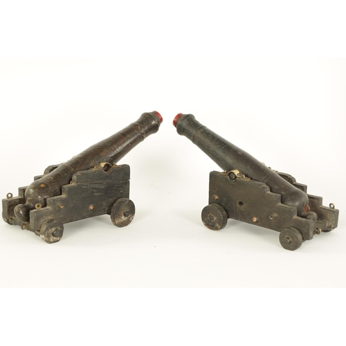 658 - A PAIR OF 19TH CENTURY CARVED WOOD CANNON MODELS modelled from the armour of Lord Nelson's HMS Victo... 