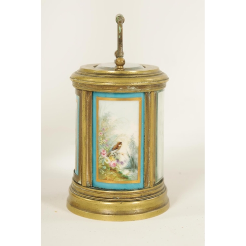 690 - A LATE 19TH CENTURY FRENCH OVAL MINIATURE PORCELAIN PANELLED CARRIAGE CLOCK the moulded brass case e... 